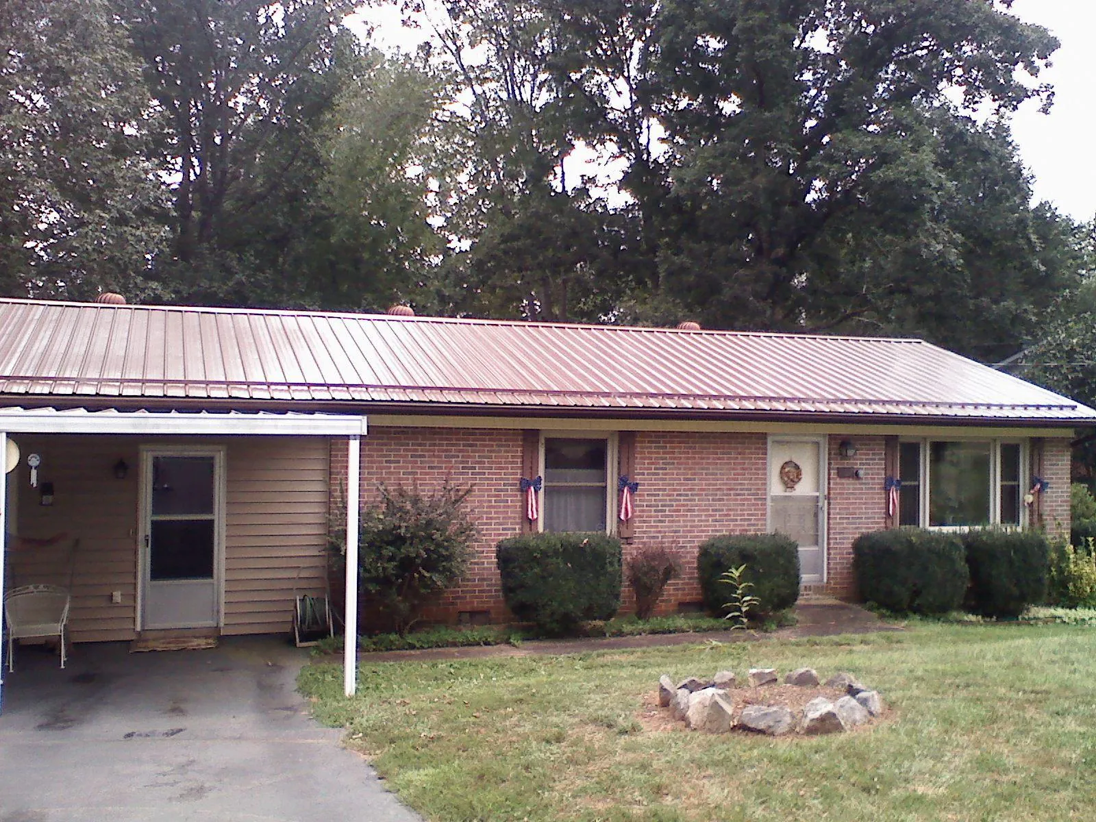 Bronze metal roof and carport on a brick ranch home — Roof Repair work by our crew in Townley